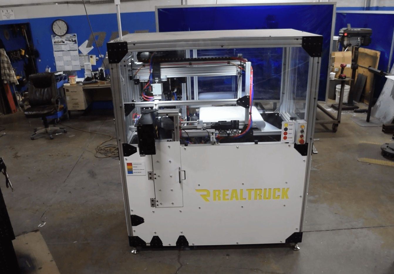 Igus gantry robot in automated drilling machine for ladder support legs of pick-up truck caps.